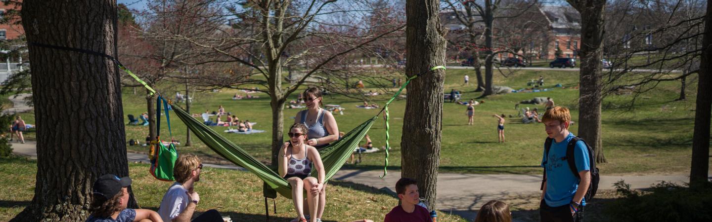 UNH students on campus in hammocks