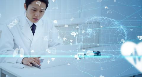 Scientist in lab coat looking at computer with digital graphics swirling around him