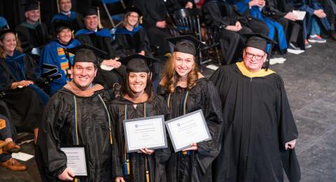 Graduate students at hooding ceremony