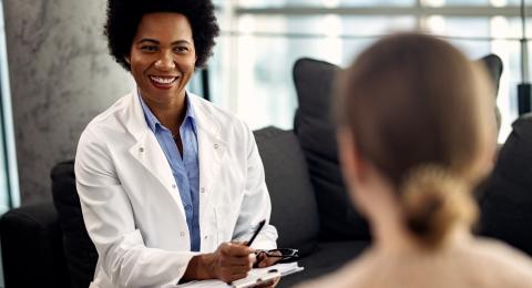 Psychiatric mental health Nurse Practitioner consulting with patient