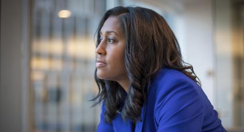 Woman wearing blue blazer staring off into the distance