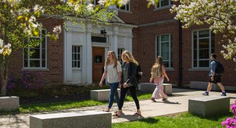 Students walking in front of James Hall in the summer