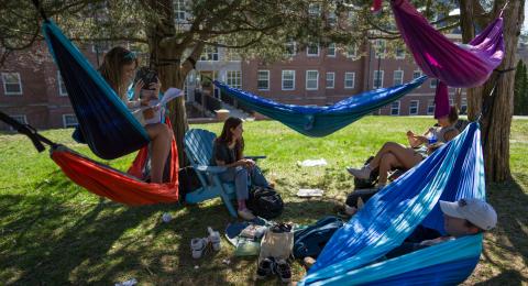 UNH students relaxing in hammock