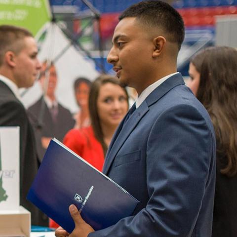 Student holding folder at career fair
