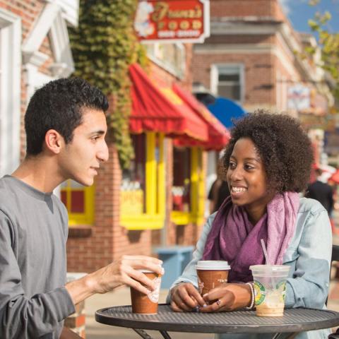 Students sitting drinking coffee in downtown Durham