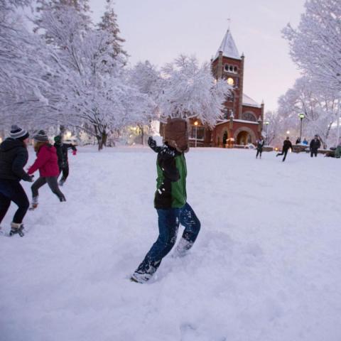 Students having a snowball fight in front of T-Hall