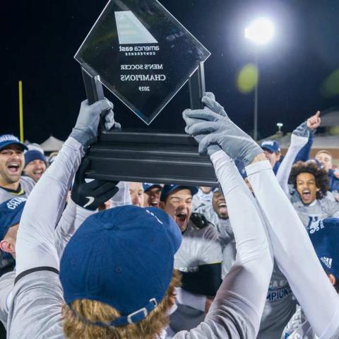 The men’s soccer team and fans celebrate their second straight America East Tournament championship at Wildcat Stadium.